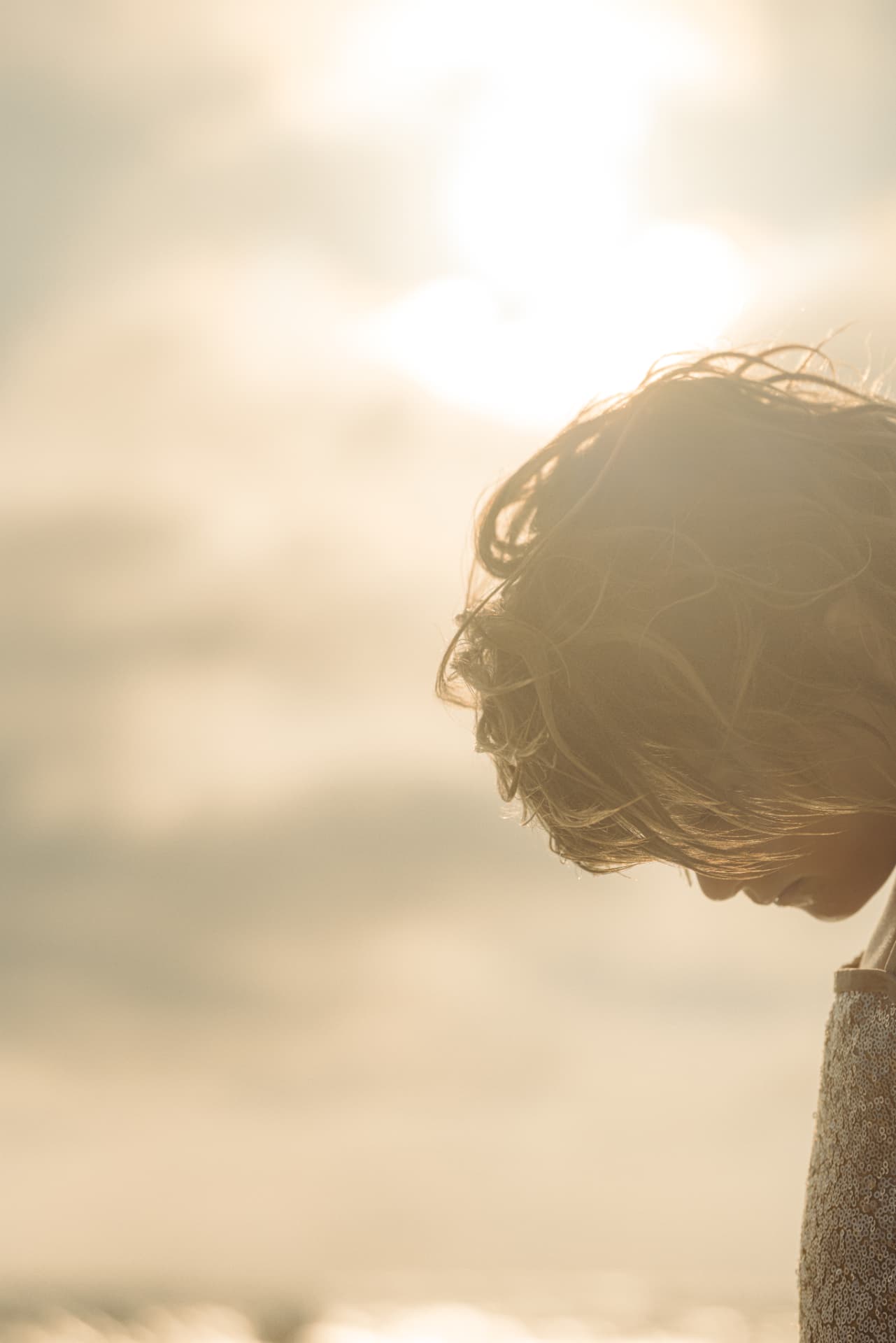 Curly hair glowing in golden hour sunlight — photo by Kathy